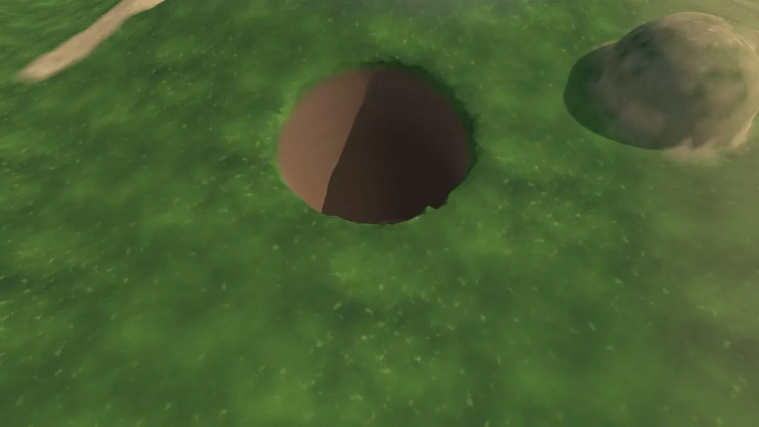A pit dug into the terrain next to a mound of added soil